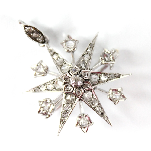 107 - A diamond starburst pendant brooch, the tiered six pointed star set throughout with rose cut diamond... 