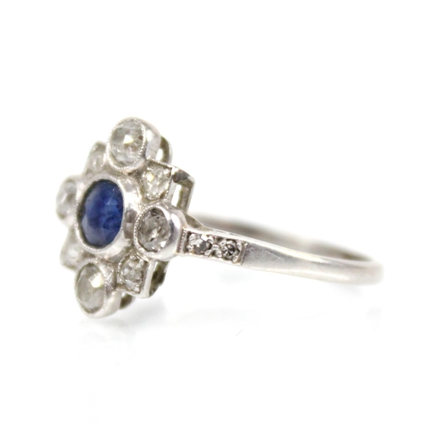 114 - An early 20th century sapphire and diamond transitional ring, the central round mixed cut sapphire m... 