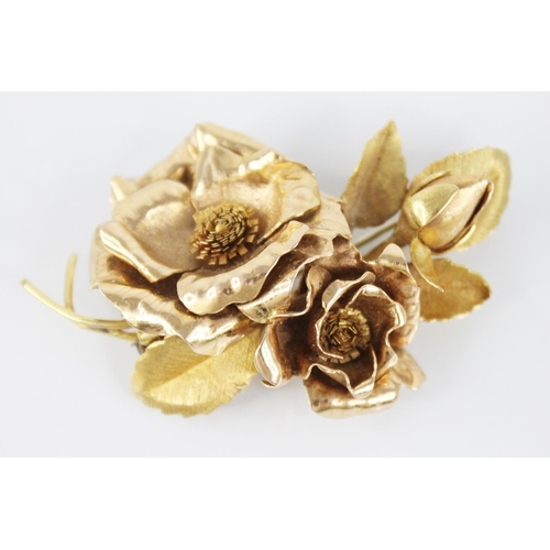 116 - An 18ct gold floral spray brooch, designed as two rose gold floral heads and a bud, set to a brushed... 