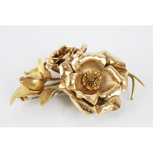 116 - An 18ct gold floral spray brooch, designed as two rose gold floral heads and a bud, set to a brushed... 