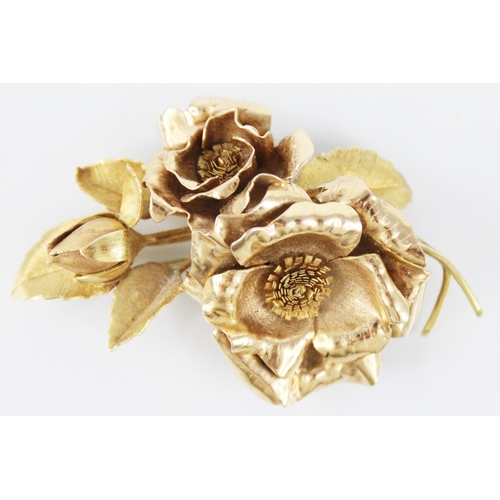 116 - An 18ct gold floral spray brooch, designed as two rose gold floral heads and a bud, set to a brushed... 