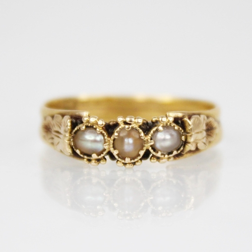 118 - A 19th century pearl set ring, comprising three off-round pearls set to gold coloured beaded borders... 