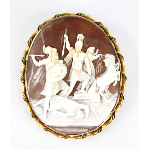 121 - A 19th century carved shell cameo brooch, the oval carved cameo depicting warring Spartan figures an... 