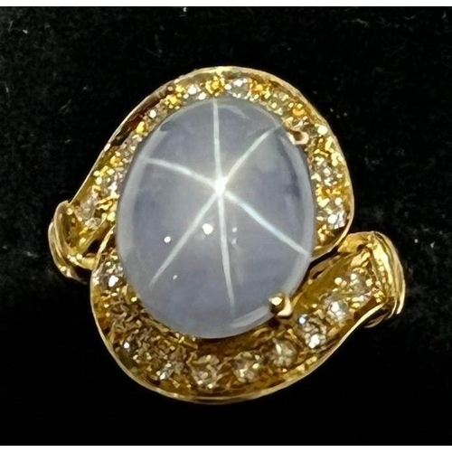 123 - A mid-20th century star sapphire and diamond 18ct gold ring, the central oval cabochon blue sapphire... 