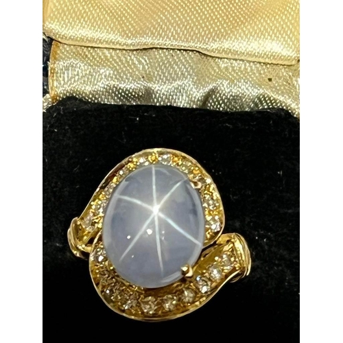 123 - A mid-20th century star sapphire and diamond 18ct gold ring, the central oval cabochon blue sapphire... 