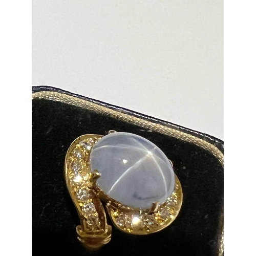 123 - A mid-20th century star sapphire and diamond 18ct gold ring, the central oval cabochon blue sapphire... 