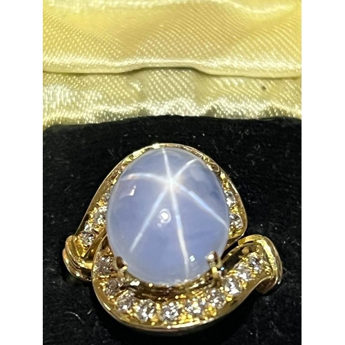 123 - A mid-20th century star sapphire and diamond 18ct gold ring, the central oval cabochon blue sapphire... 