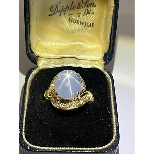 123 - A mid-20th century star sapphire and diamond 18ct gold ring, the central oval cabochon blue sapphire... 