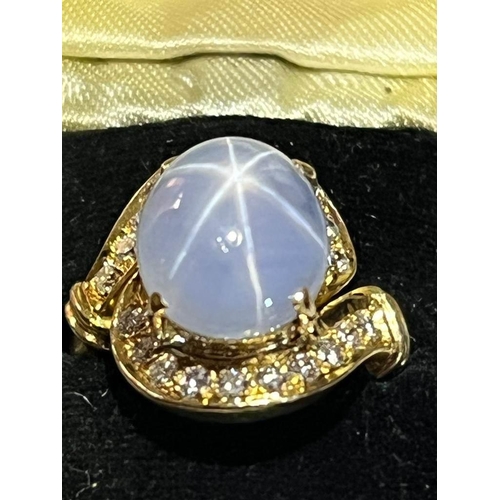 123 - A mid-20th century star sapphire and diamond 18ct gold ring, the central oval cabochon blue sapphire... 