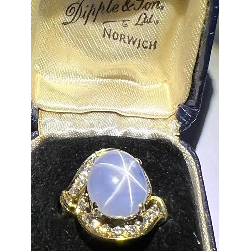 123 - A mid-20th century star sapphire and diamond 18ct gold ring, the central oval cabochon blue sapphire... 