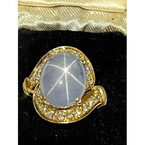 123 - A mid-20th century star sapphire and diamond 18ct gold ring, the central oval cabochon blue sapphire... 