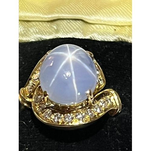 123 - A mid-20th century star sapphire and diamond 18ct gold ring, the central oval cabochon blue sapphire... 