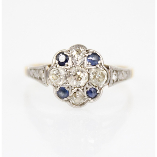 128 - An early 20th century sapphire and diamond floral cluster ring, the central floral head set with fiv... 