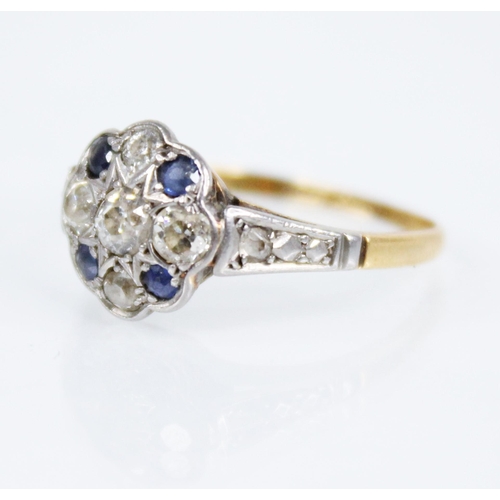 128 - An early 20th century sapphire and diamond floral cluster ring, the central floral head set with fiv... 