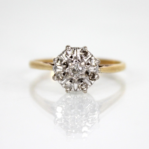 131 - A diamond floral cluster ring, the central brilliant cut diamond with a surround of eight further si... 