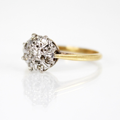 131 - A diamond floral cluster ring, the central brilliant cut diamond with a surround of eight further si... 