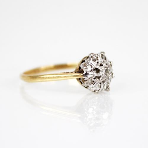 131 - A diamond floral cluster ring, the central brilliant cut diamond with a surround of eight further si... 