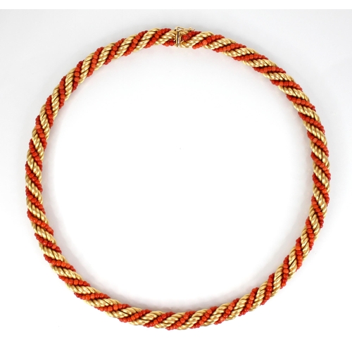 135 - A mid-20th century Italian 18ct gold and coral necklace, the rope twist chain entwined coral beads, ... 