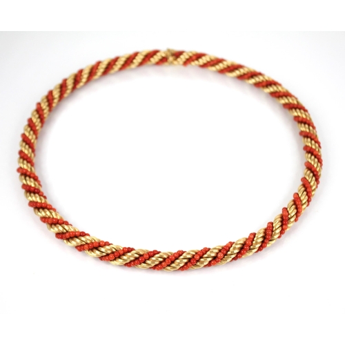 135 - A mid-20th century Italian 18ct gold and coral necklace, the rope twist chain entwined coral beads, ... 