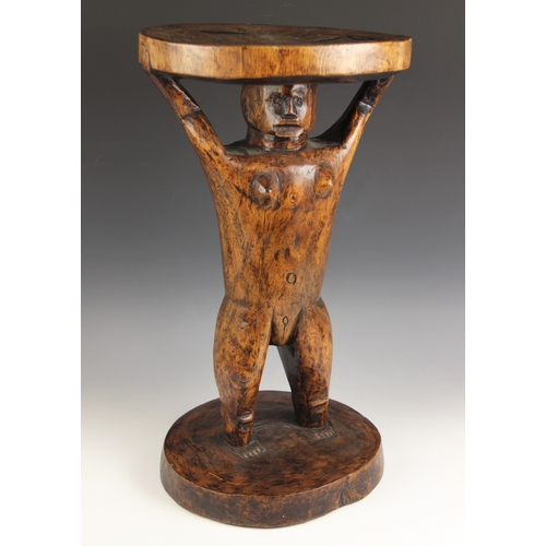 430 - A Southern African Shona Zimbabwe tribal art stool with figure and carved designed to the top, 53cm ... 