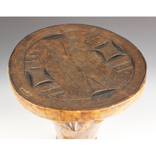 430 - A Southern African Shona Zimbabwe tribal art stool with figure and carved designed to the top, 53cm ... 