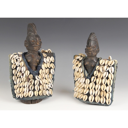 434 - A pair of West African Nigerian tribal art Ibeji dolls with cowrie shell jackets, 24.5cm high (2)