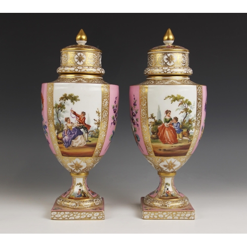 466 - A pair of Dresden porcelain urn shaped vases and covers, early 20th century, decorated in the manner... 