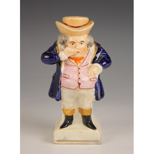 480 - A Staffordshire figure modelled as a standing snuff taker, 19th century, the figure with pink waistc... 