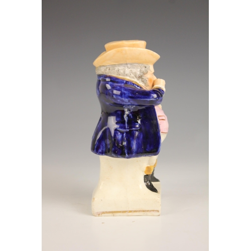 480 - A Staffordshire figure modelled as a standing snuff taker, 19th century, the figure with pink waistc... 