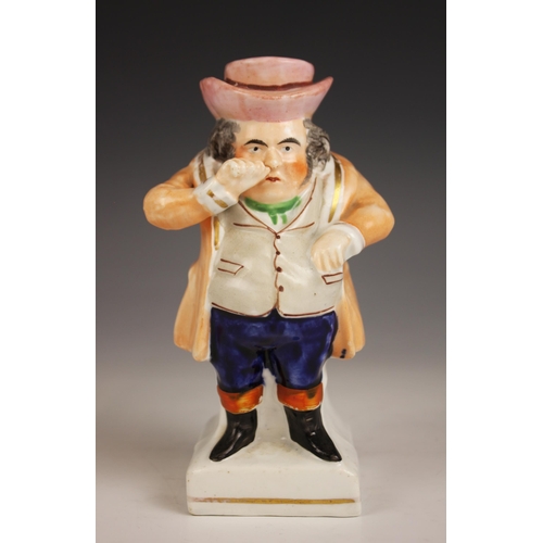 481 - A Staffordshire figure modelled as a standing snuff taker, 19th century, the figure with beige waist... 