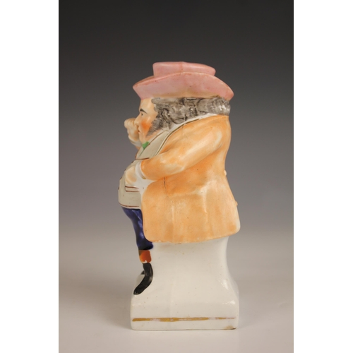 481 - A Staffordshire figure modelled as a standing snuff taker, 19th century, the figure with beige waist... 