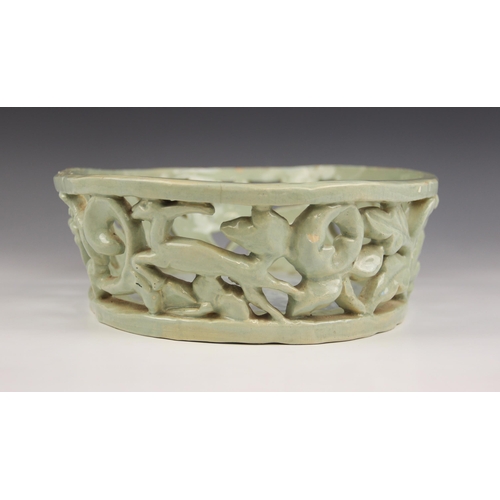 489 - An Art Deco, Art Pottery shallow pierced basket of oval form, the gallery depicting leaping deer and... 