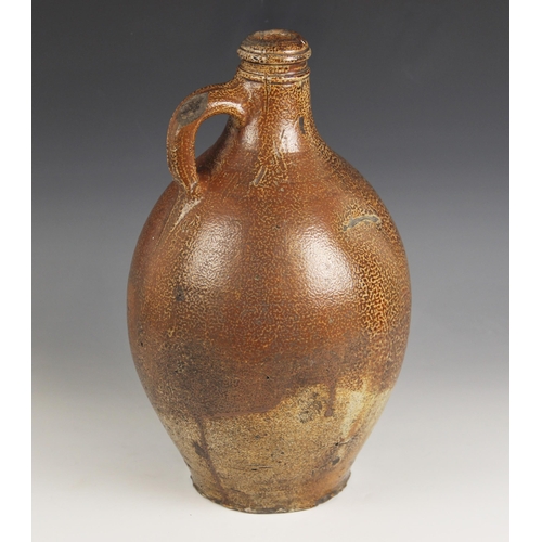 491 - A large German stoneware salt glazed jug, 17th century, of large ovoid proportions with small loop h... 