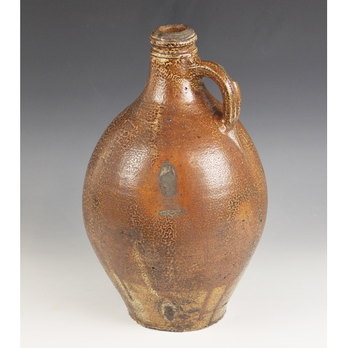 491 - A large German stoneware salt glazed jug, 17th century, of large ovoid proportions with small loop h... 