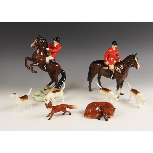 494 - A Beswick hunting group, comprising a Beswick Huntsman on rearing horse, model no. 868, a Beswick Hu... 