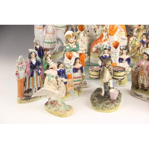 503 - A selection of twenty 19th century and later Staffordshire figures, to include a posy vase modelled ... 