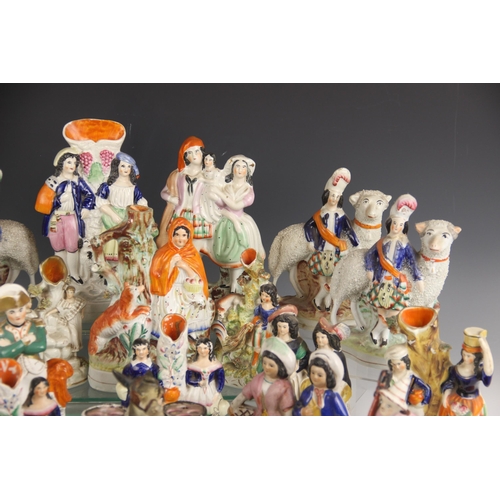 503 - A selection of twenty 19th century and later Staffordshire figures, to include a posy vase modelled ... 