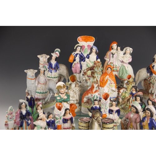 503 - A selection of twenty 19th century and later Staffordshire figures, to include a posy vase modelled ... 