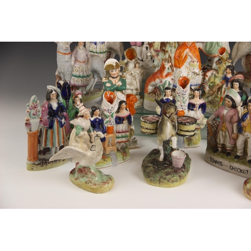 503 - A selection of twenty 19th century and later Staffordshire figures, to include a posy vase modelled ... 