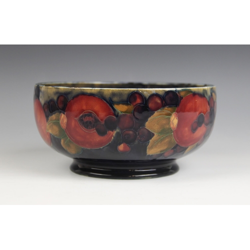 515 - A Moorcroft pomegranate pattern footed bowl, mid 20th century, impressed marks and blue painted Will... 