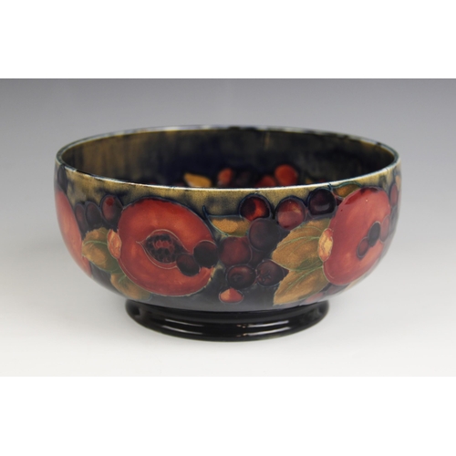 515 - A Moorcroft pomegranate pattern footed bowl, mid 20th century, impressed marks and blue painted Will... 