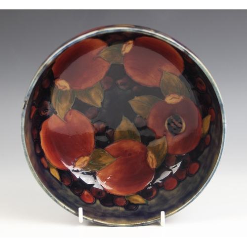 515 - A Moorcroft pomegranate pattern footed bowl, mid 20th century, impressed marks and blue painted Will... 