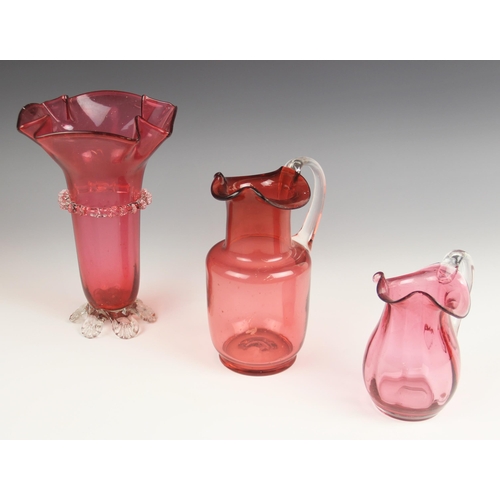 518 - A cranberry glass vase, 19th century, with flared folded rim and prunted central band and feet, unpo... 