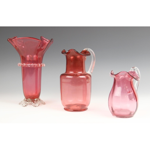 518 - A cranberry glass vase, 19th century, with flared folded rim and prunted central band and feet, unpo... 