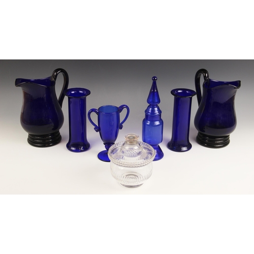 519 - A collection of Bristol blue glass wares to to include a pair of water jugs 21.5cm high (at fault), ... 