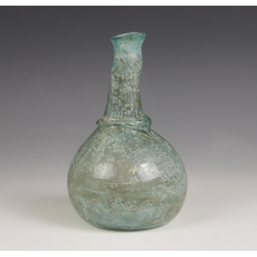 521 - A Roman glass bottle, circa 1st Century AD, the spherical body with tapering cylindrical neck, trail... 