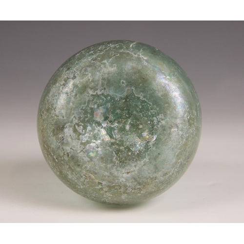 521 - A Roman glass bottle, circa 1st Century AD, the spherical body with tapering cylindrical neck, trail... 