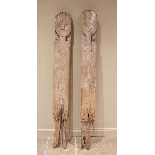 551 - A pair of Indonesian Loro Blonyo gate posts, early 20th century, the weathered and gnarled timber ca... 