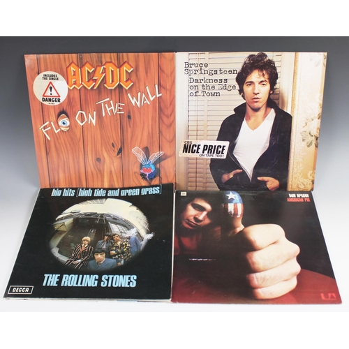 561 - A collection of vinyl rock and pop LPs, to include albums by The Rolling Stones, AC/DC, Bruce Spring... 