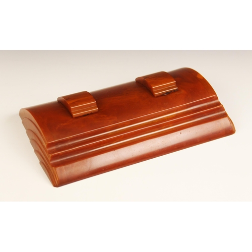 579 - An Art Deco amber Bakelite desk stand (possibly Carvacraft), of Odeonesque form with integral pen re... 